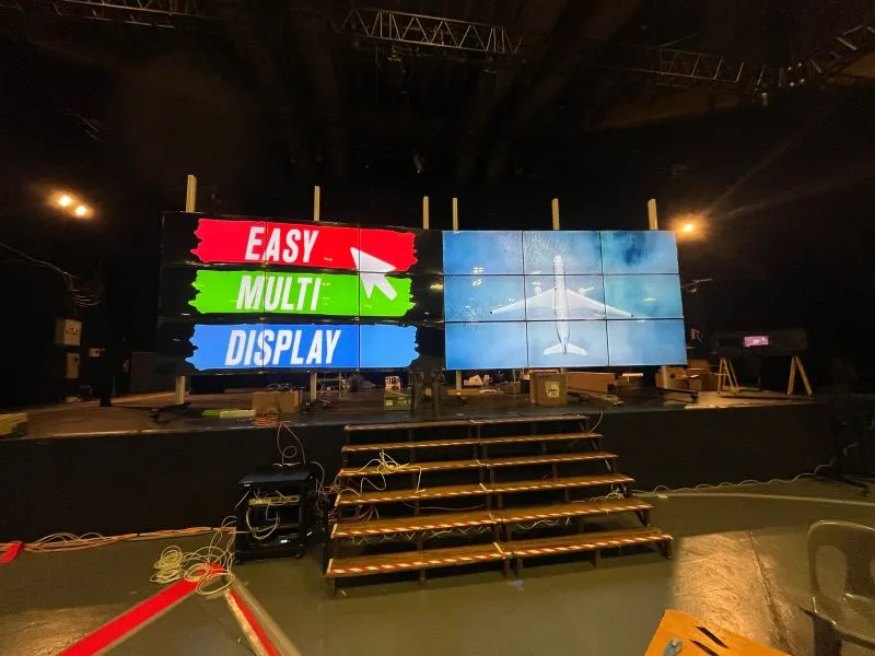 The two 9-screen walls of Lourdes 2026 assembled and aligned, one showing the Easy Multi Display logo, the other an aircraft image